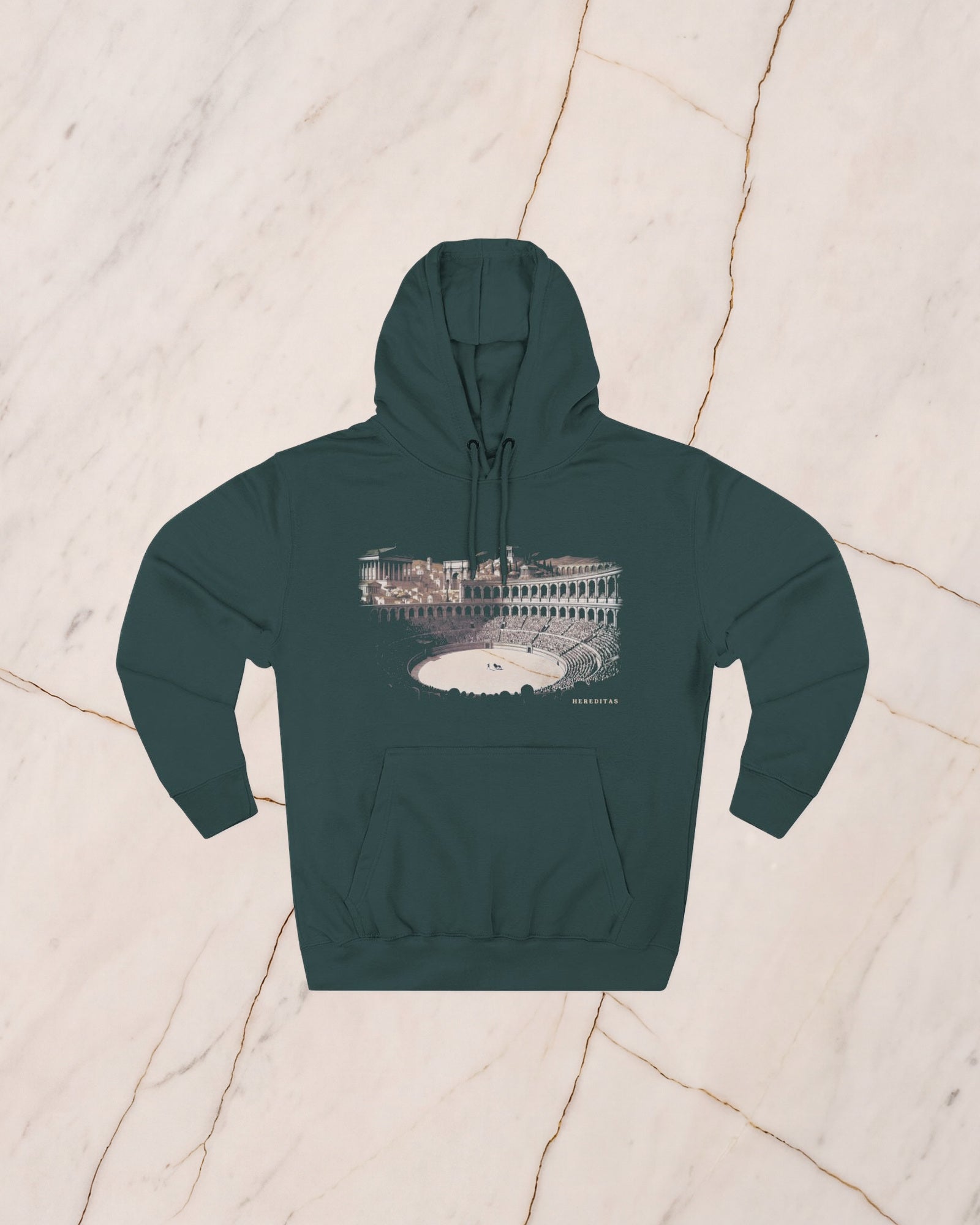 The VENATOR hoodie in sports green, a deep pine, laid flat on pale marble. A hunter and a lion alone on the arena sand, the temples of the city rising beyond the wall, drawn in bone line and lit by a low sun.