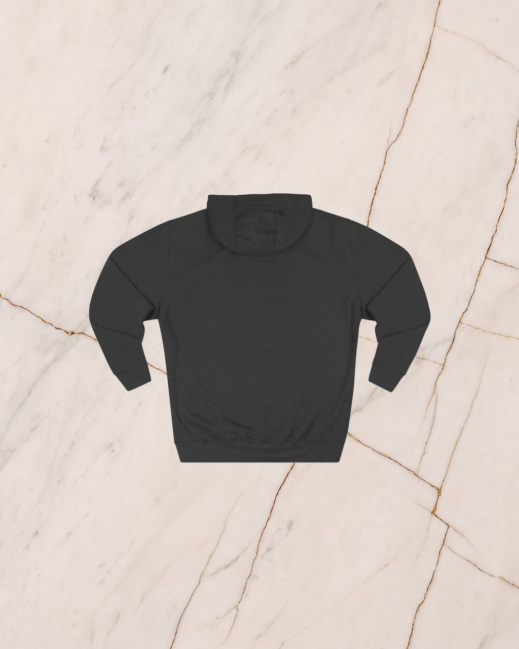 The back of the VENATOR hoodie in charcoal heather, unprinted, laid flat on pale marble.